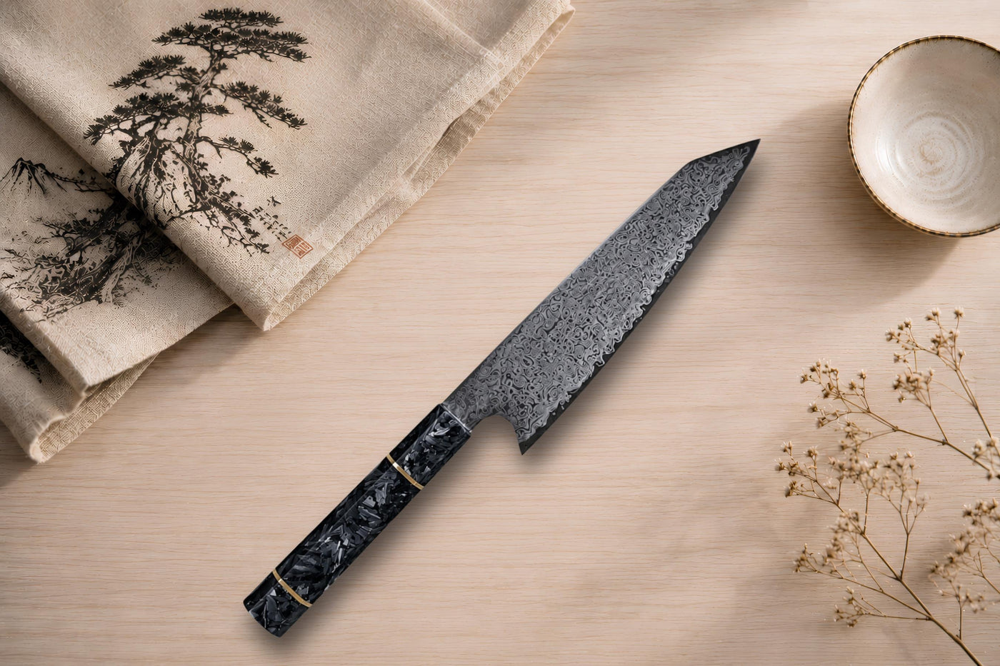 A Damascus steel Kiritsuke chef's knife with a carbon-fibre handle